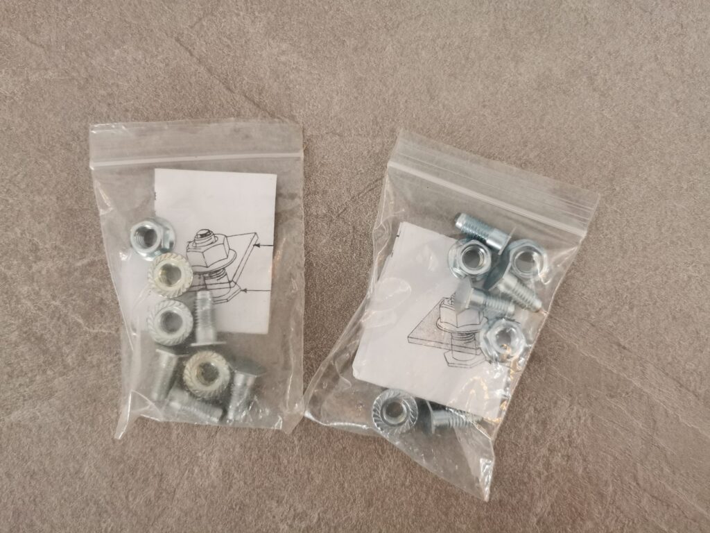Two plastic bags with large screw-in studs for horse shoes,