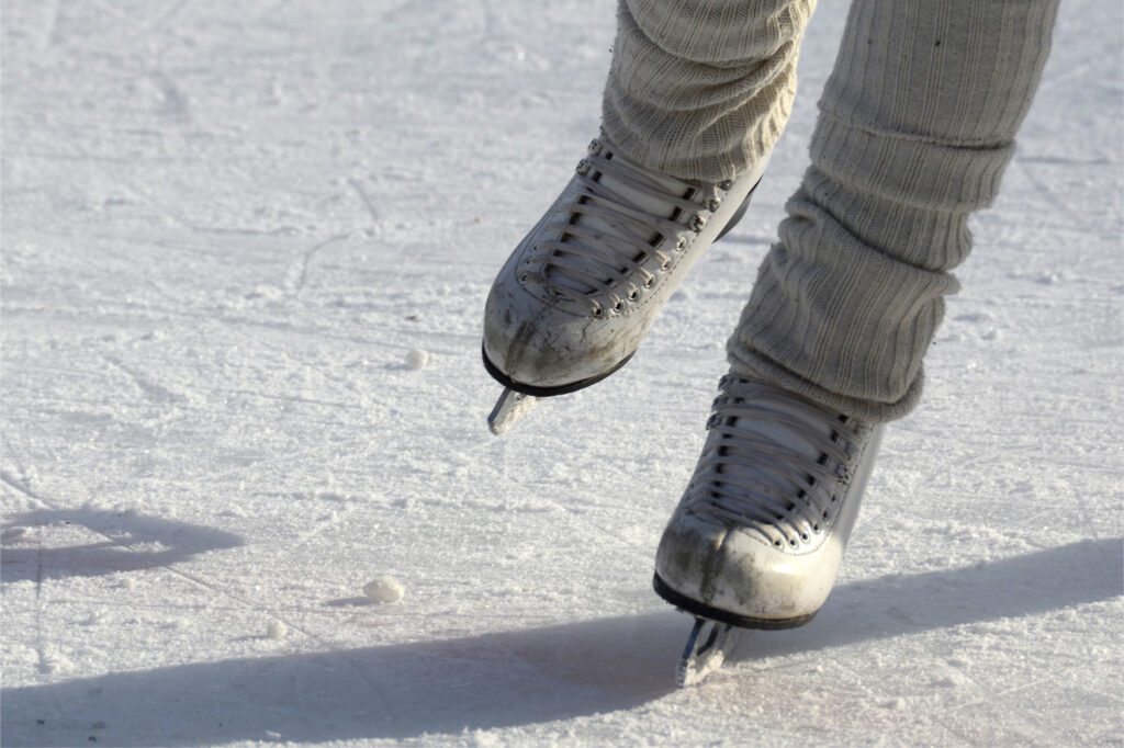 White skates shown skating on ice